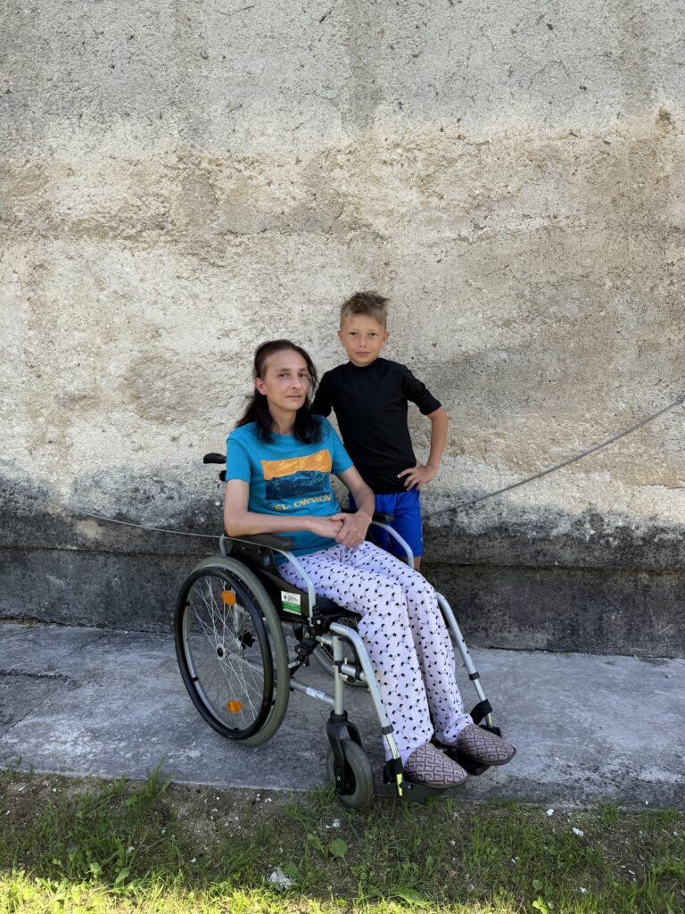 Sefija Hušić in a wheelchair with her young son